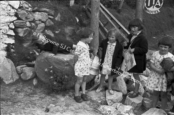 CHILDREN WAITING IN GROUP AT SIDE OF ROAD